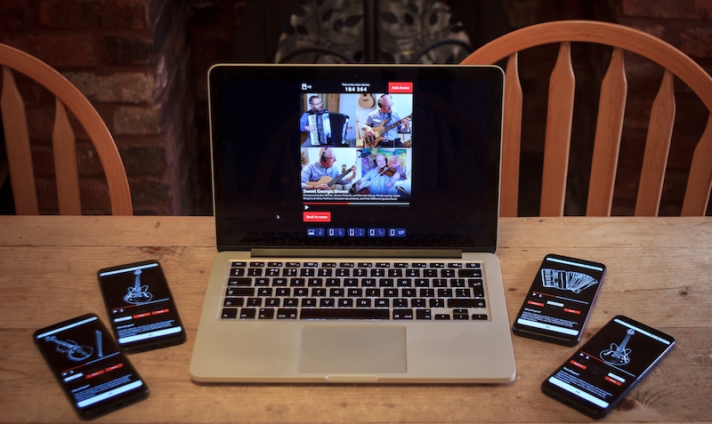 Promotional picture for Pick A Part, four phones with different instrument images on them on a table next to a laptop